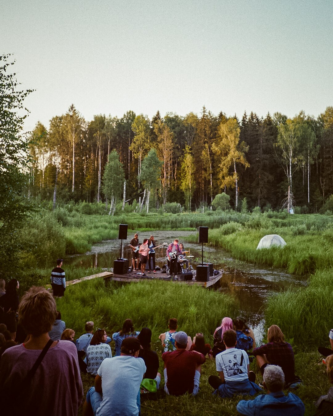 Outdoor community concert with crowd and stage lights